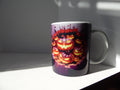 White ceramic mug with orange jack-o’-lantern artwork and a purple printed broken-wall border