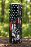 Flag and dog-tag side of the tumbler in a woodland setting
