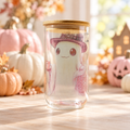 Witch hat ghost clear glass cup front in a cozy Halloween setting