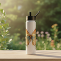 Butterfly stainless steel Hydro bottle displayed in a bright garden-inspired setting
